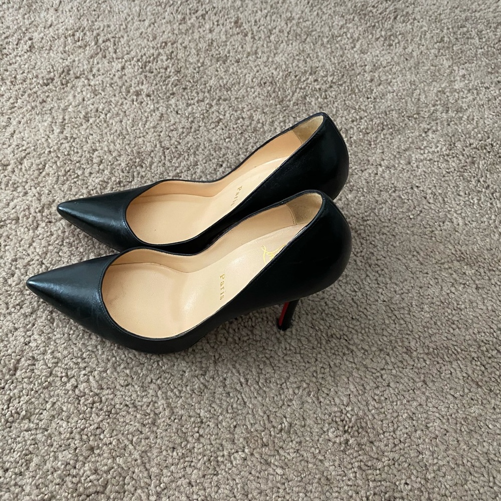 Black Christian Louboutin pumps.